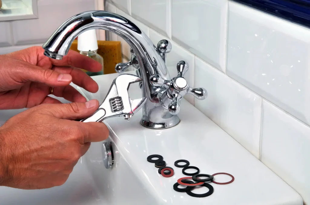 Plumber performing maintenance on a bathroom faucet in Port Charlotte