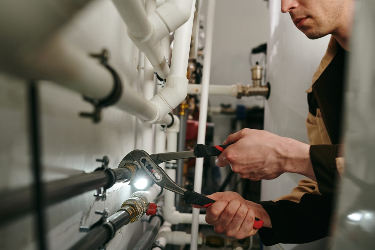 Plumbers maintaining commercial plumbing pipes in Port Charlotte