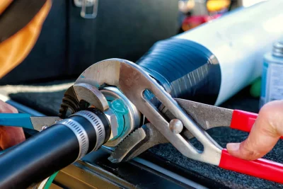 Technician tightening an industrial pipe connection in Port Charlotte