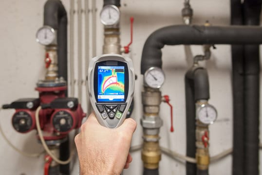 Plumber using a thermal imaging camera to inspect pipes in Port Charlotte