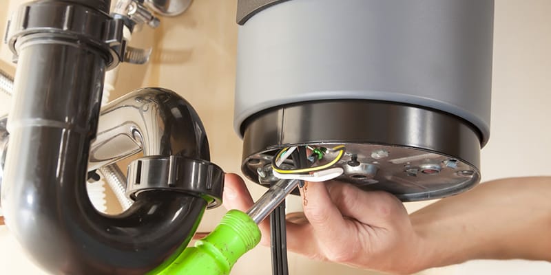 Technician repairing the heating element of a water heater in Port Charlotte