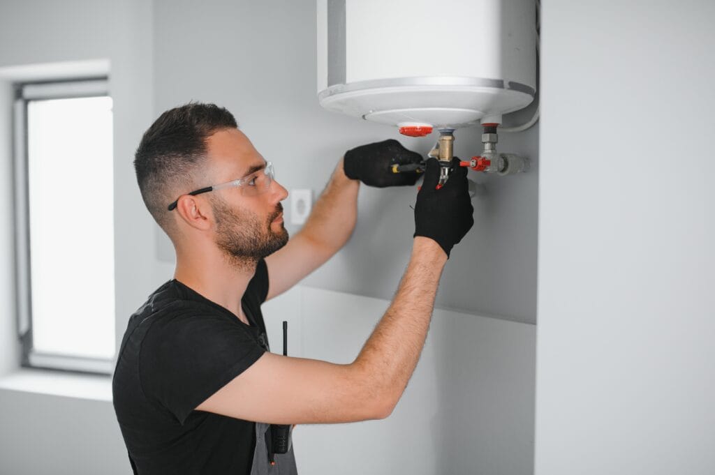 Technician performing water heater maintenance in Port Charlotte