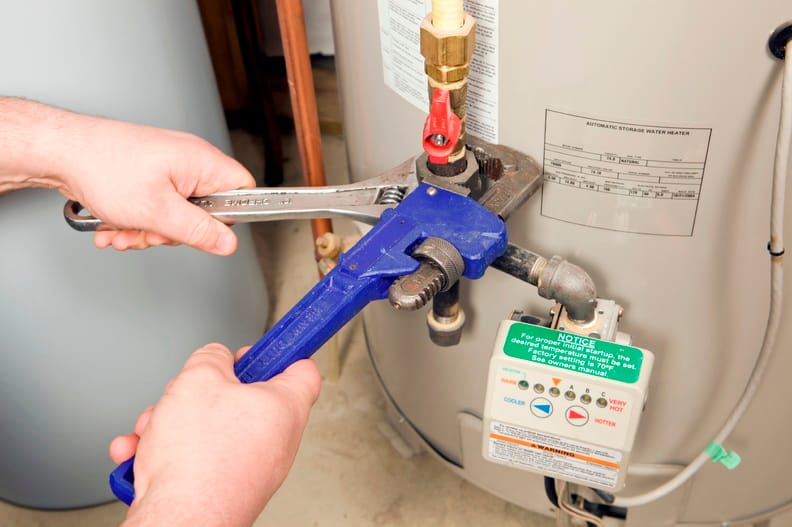 Plumber repairing a water heater valve in Port Charlotte